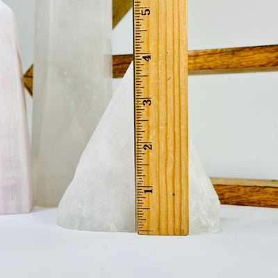 crystal quartz point next to a ruler for size reference