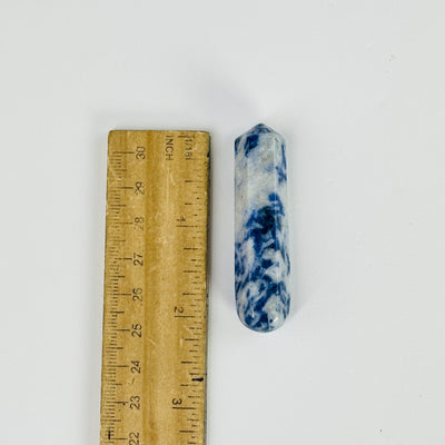 sodalite massage wand next to a ruler for size reference