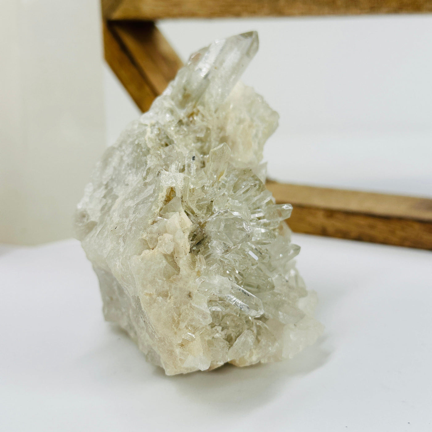 crystal quartz cluster with decorations in the background