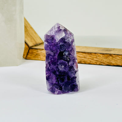 AMETHYST point with decorations in the background