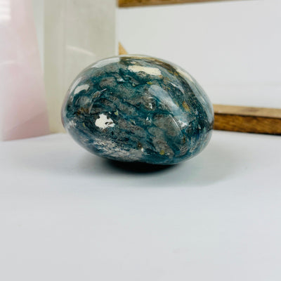 dumortierite cut base with decorations in the background