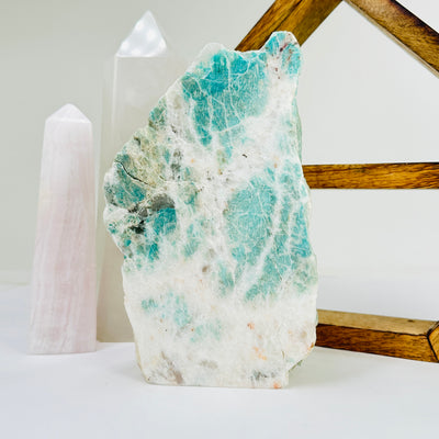 amazonite cut base with decorations in the background