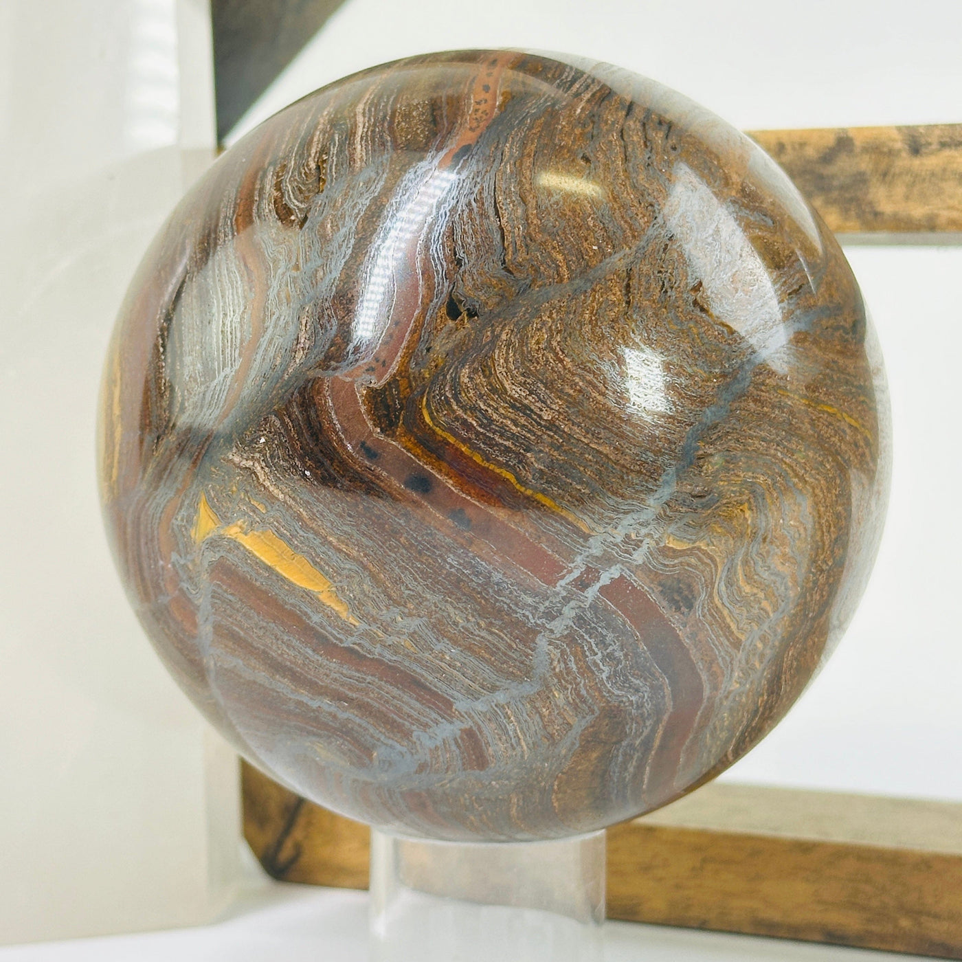 tigers eye sphere with decorations in the background