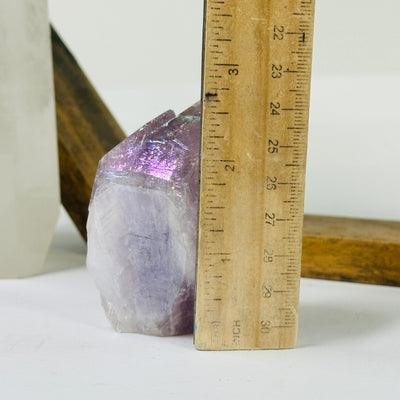 amethyst point next to a ruler for size reference