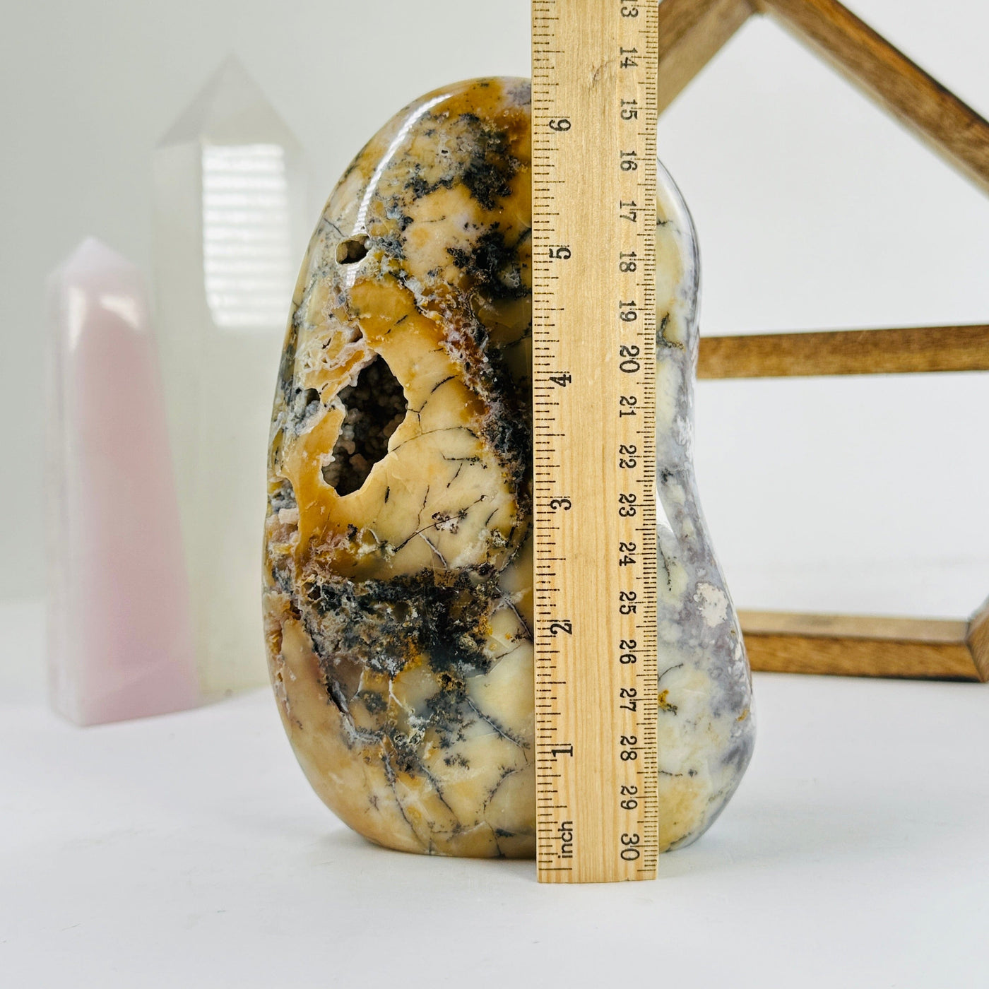 dendrite opal next to a ruler for size reference