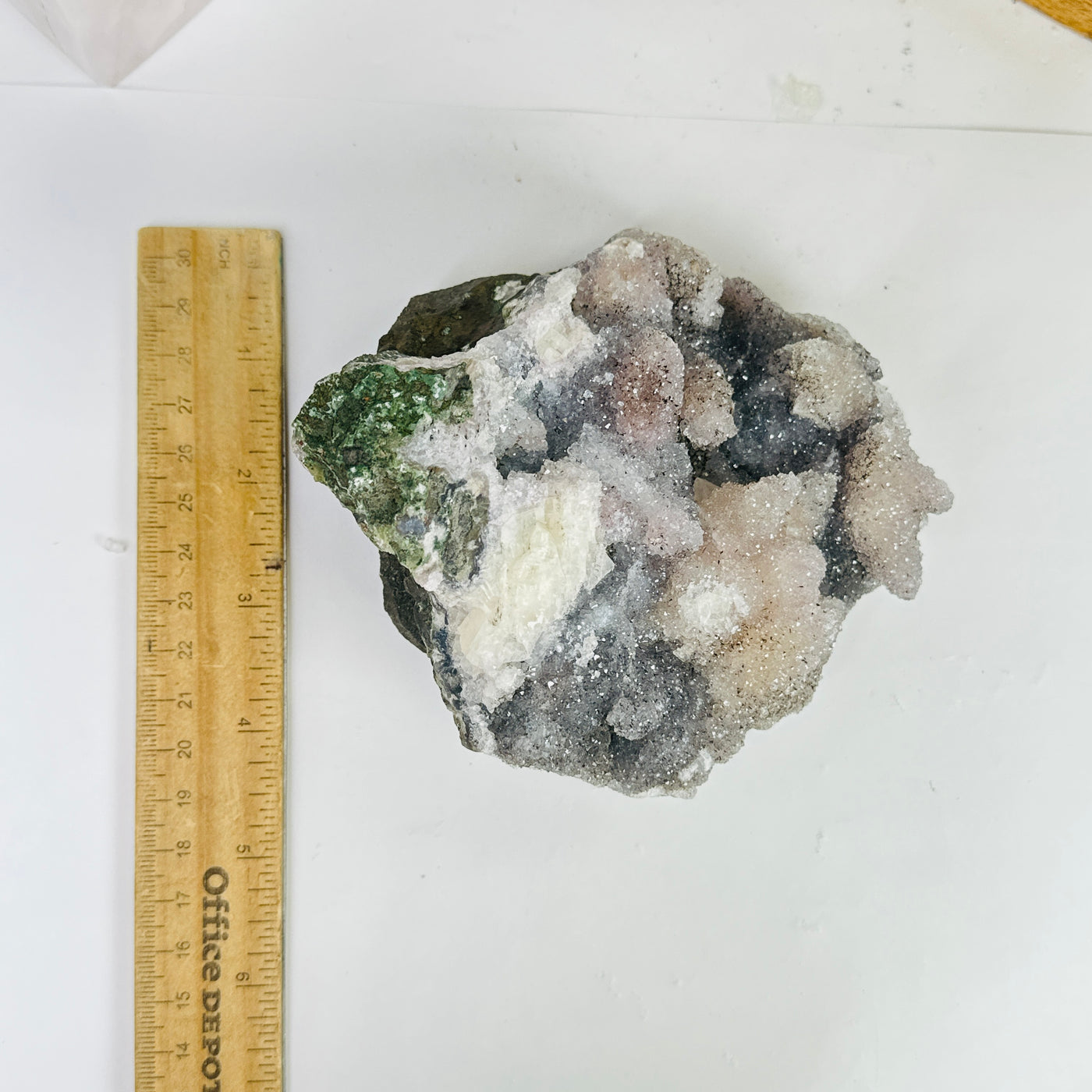 amethyst cluster next to a ruler for size reference