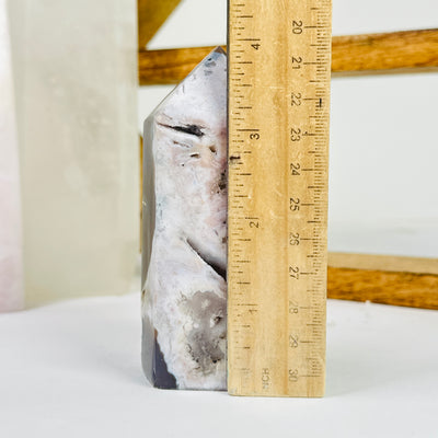 amethyst point next to a ruler for size reference