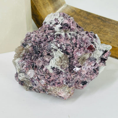 lepidolite cluster with decorations in the background