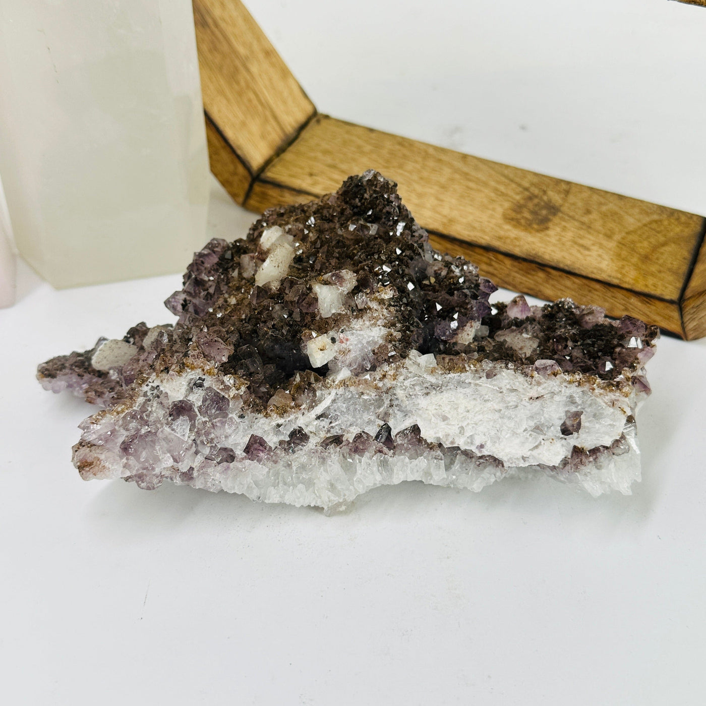 amethyst cluster with decorations in the background