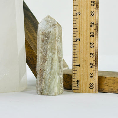 tourmaline point next to a ruler for size reference