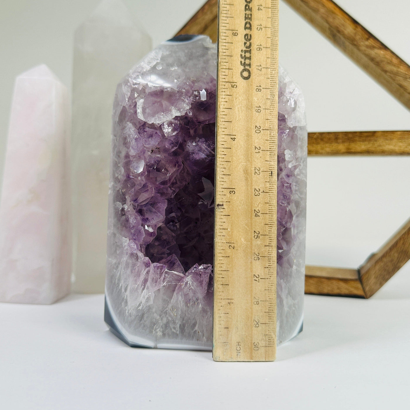 amethyst point next to a ruler for size reference