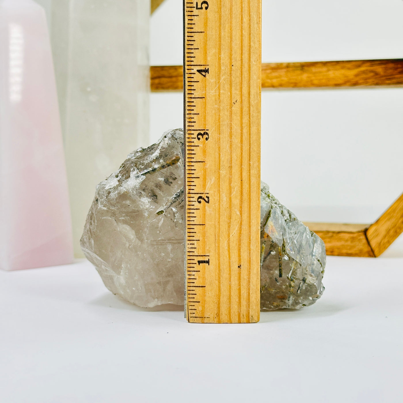 tourmaline on alligator quartz next to a ruler for size reference