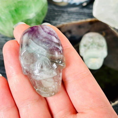 Fluorite Laughing Skull Crystal Cabochon - You Choose variant 1 in hand for size reference with other variant in background