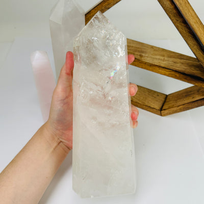 crystal quartz point with decorations in the background