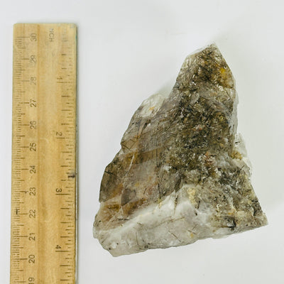 smokey quartz next to a ruler for size reference