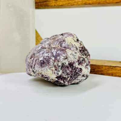 lepidolite with decorations in the background