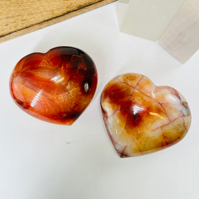 carnelian heart with decorations in the background