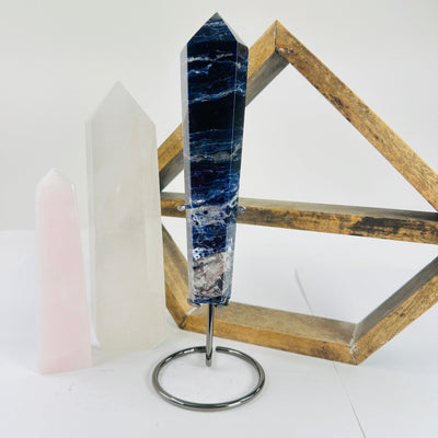 sodalite point with decorations in the background