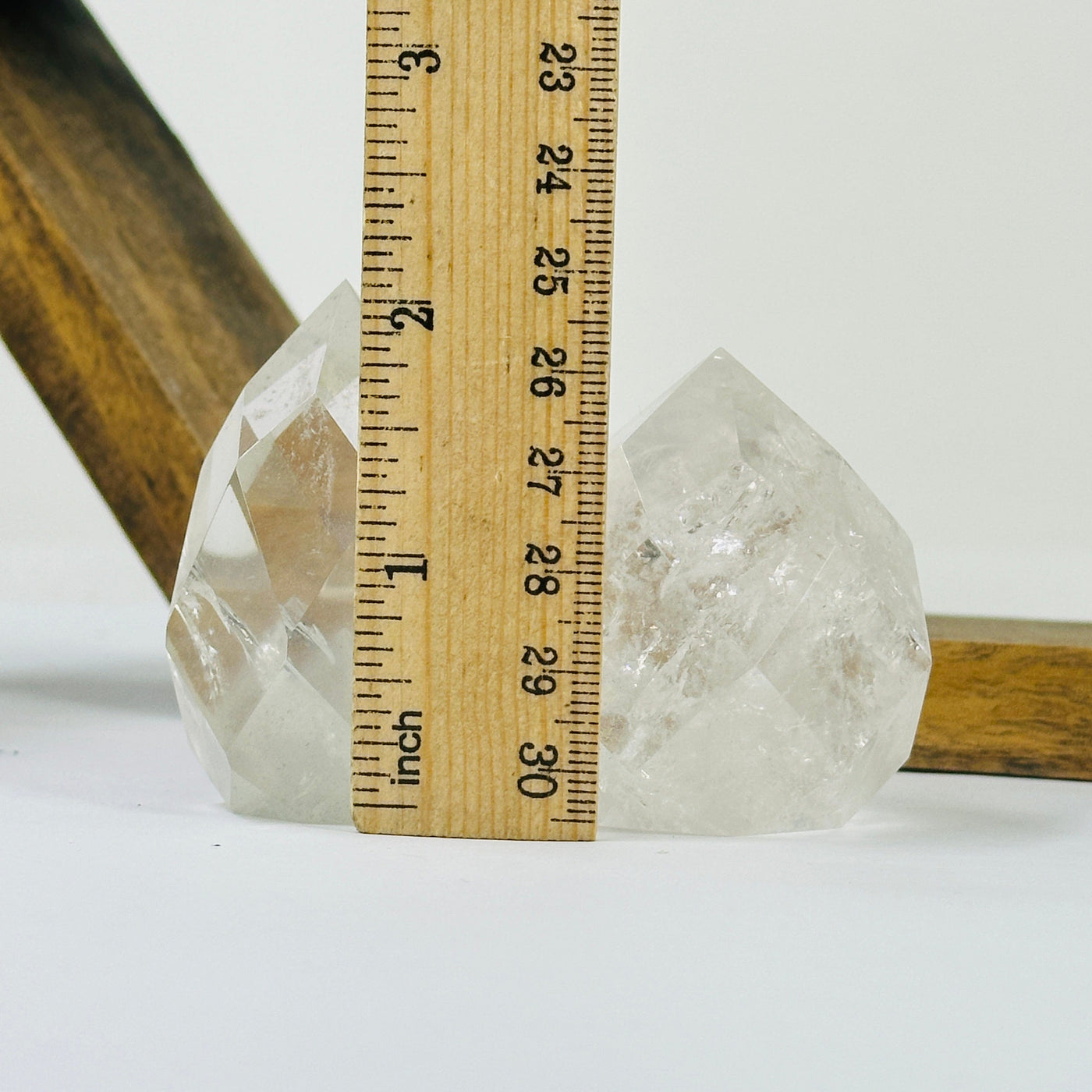 crystal quartz point with decorations in the background