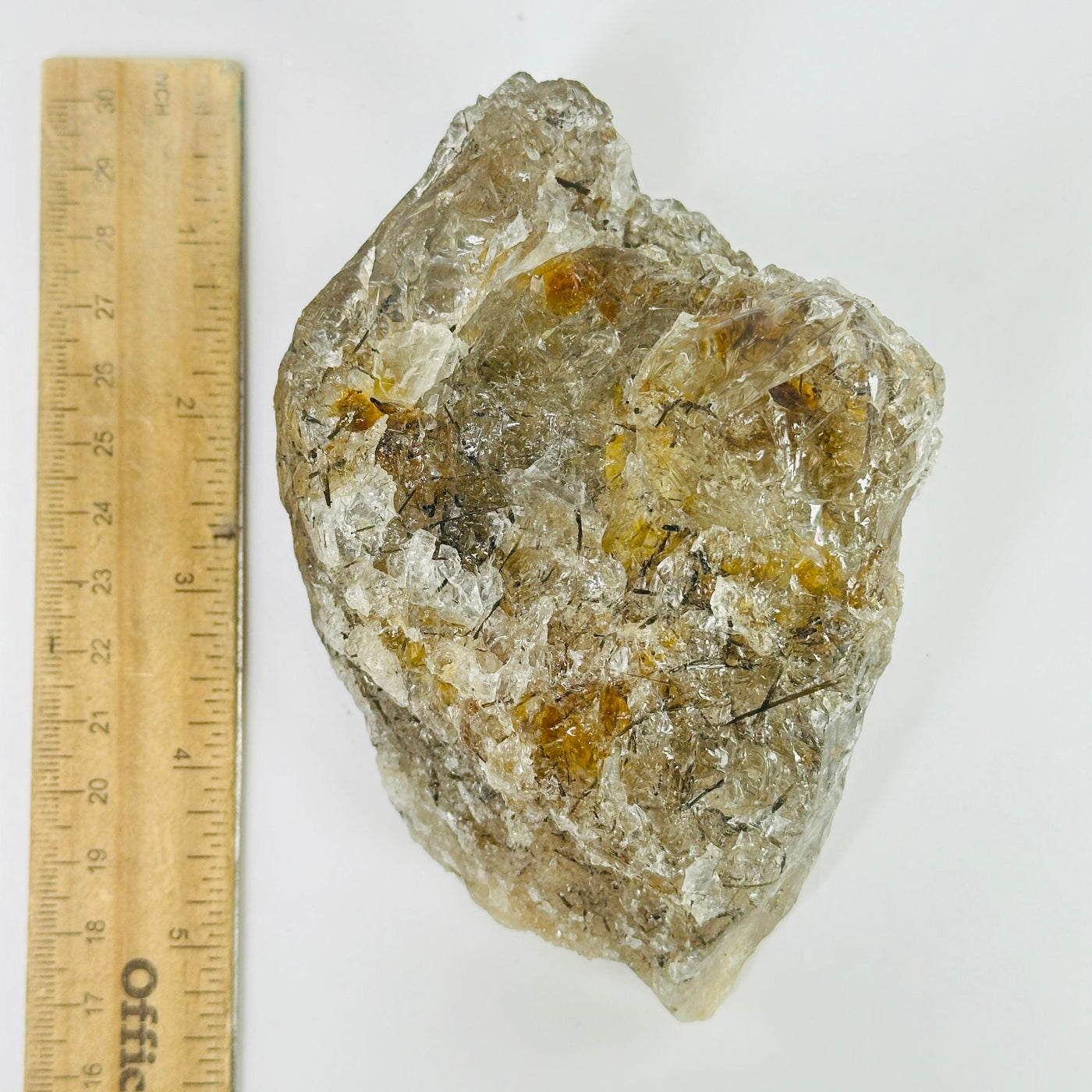 rutile quartz next to a ruler for size reference