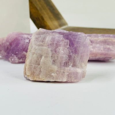 kunzite with decorations in the background