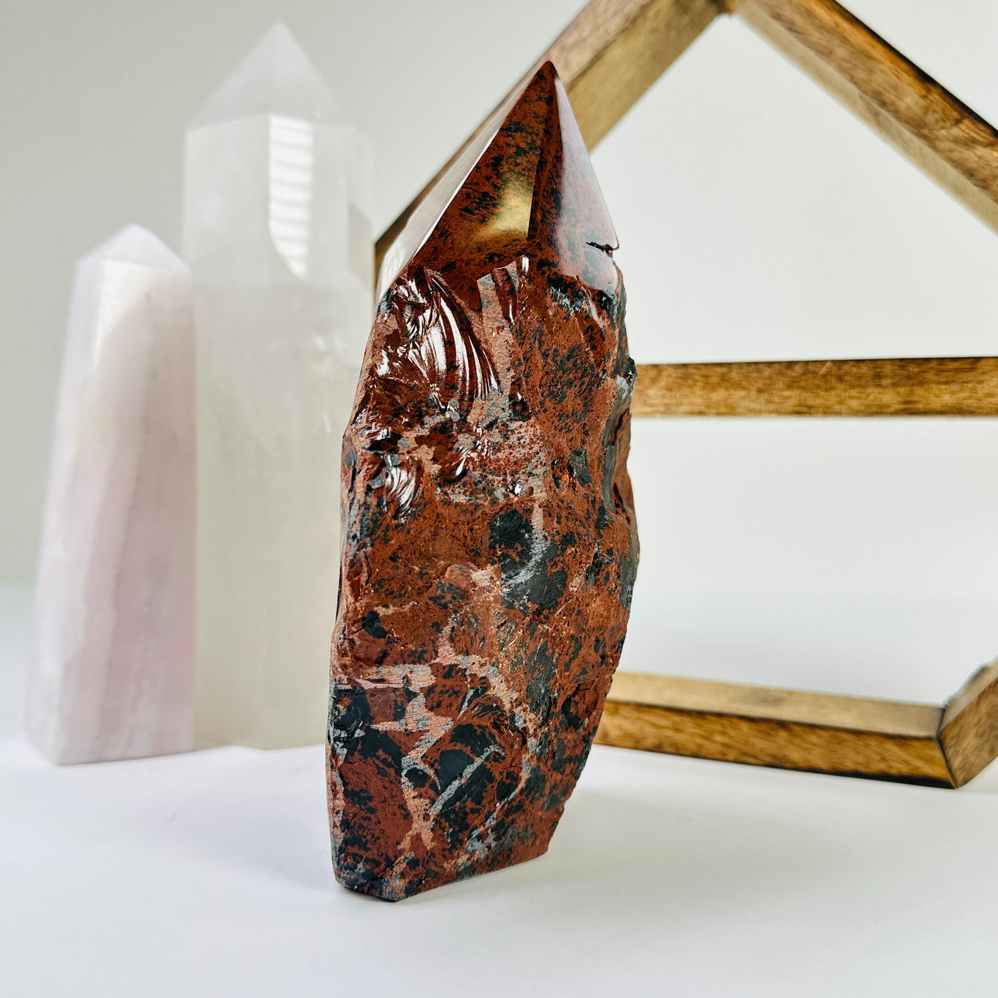 mahogany obsidian point with decorations in the background