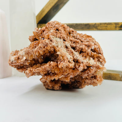 aragonite cluster with decorations in the background