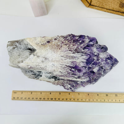 elestial amethyst next to a ruler for size reference