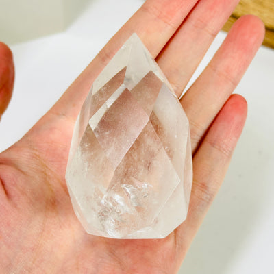 crystal quartz point with decorations in the background