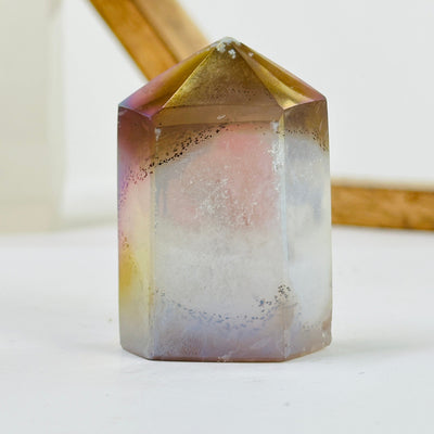 angel aura agate point with decorations in the background