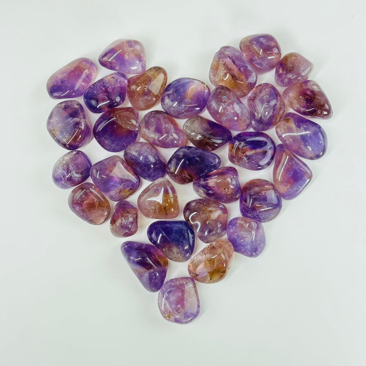 amethyst tumbled stones in a heart formation