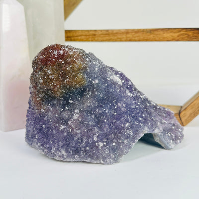 amethyst cluster with decorations in the background