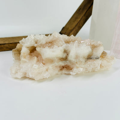 pink halite cluster with decorations in the background