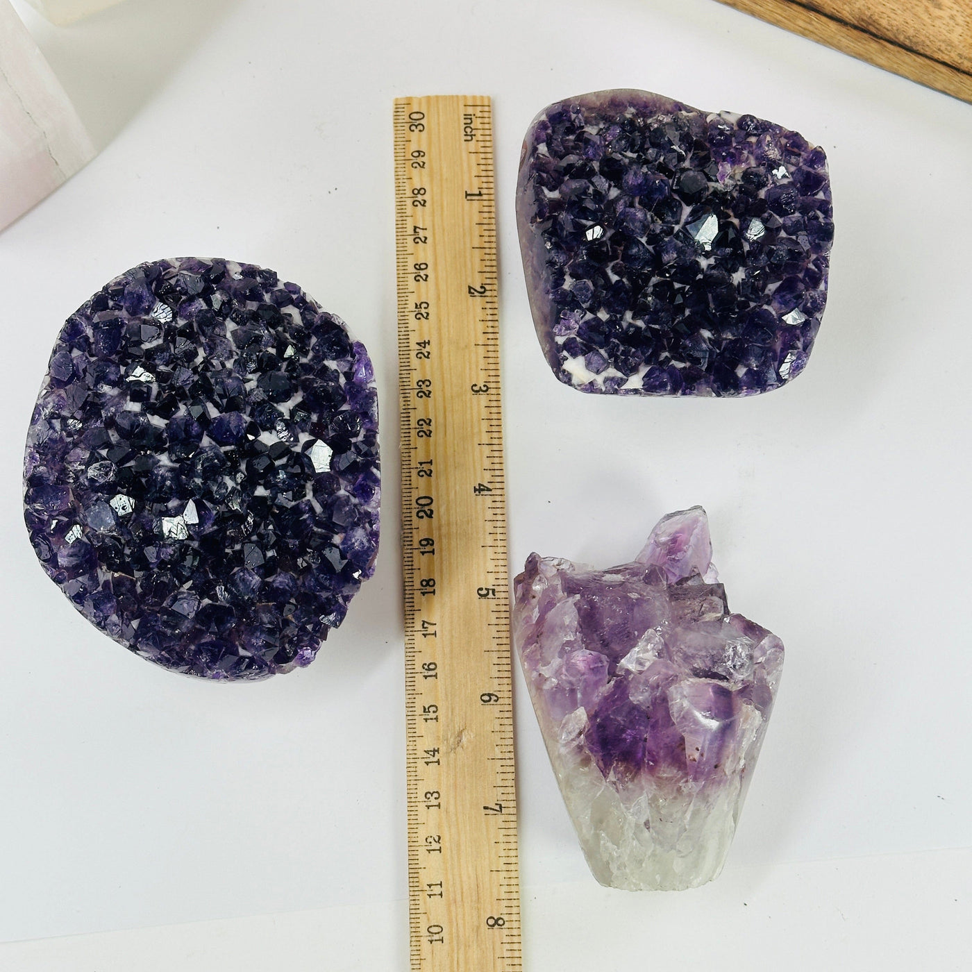 amethyst crystal flowers next to a ruler for size reference
