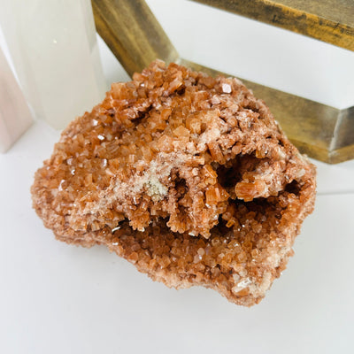 aragonite cluster with decorations in the background