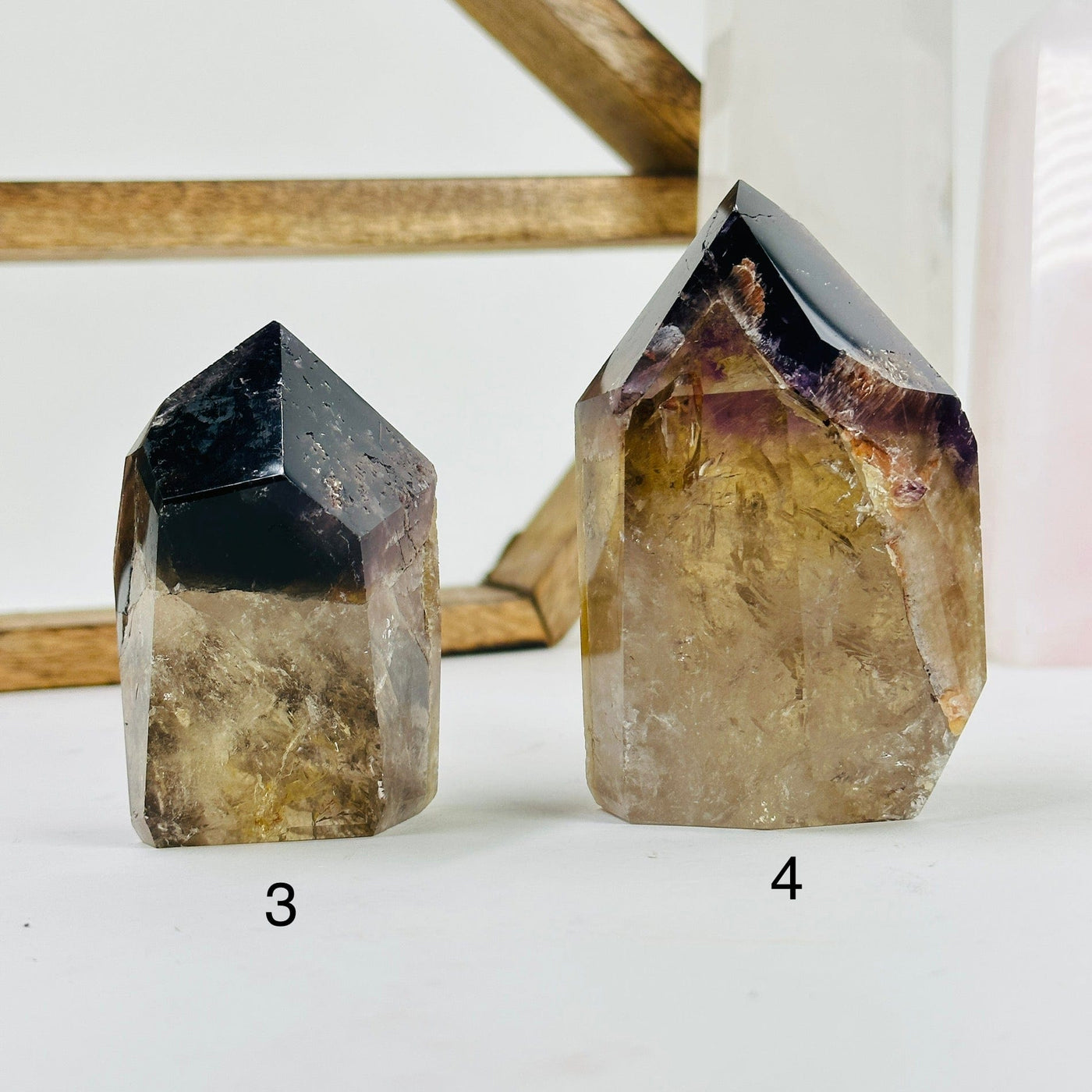ametrine polished points with decorations in the background