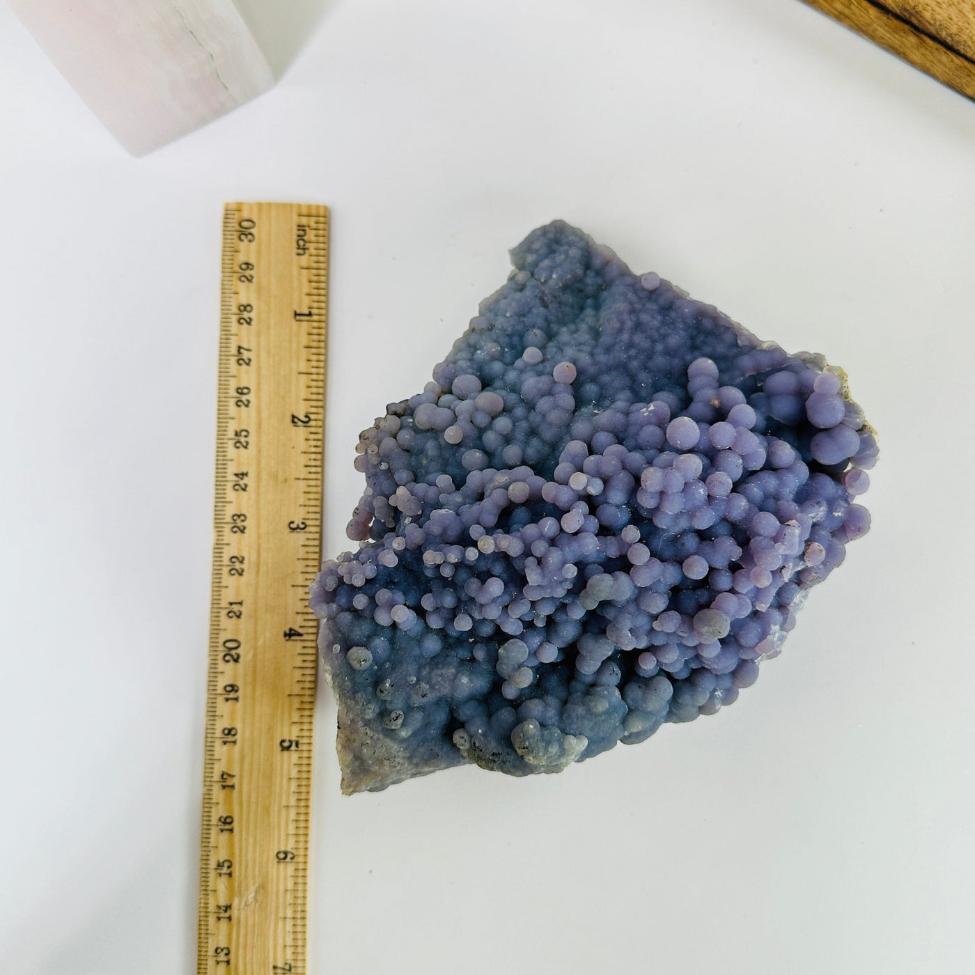 grape agate next to a ruler for size reference