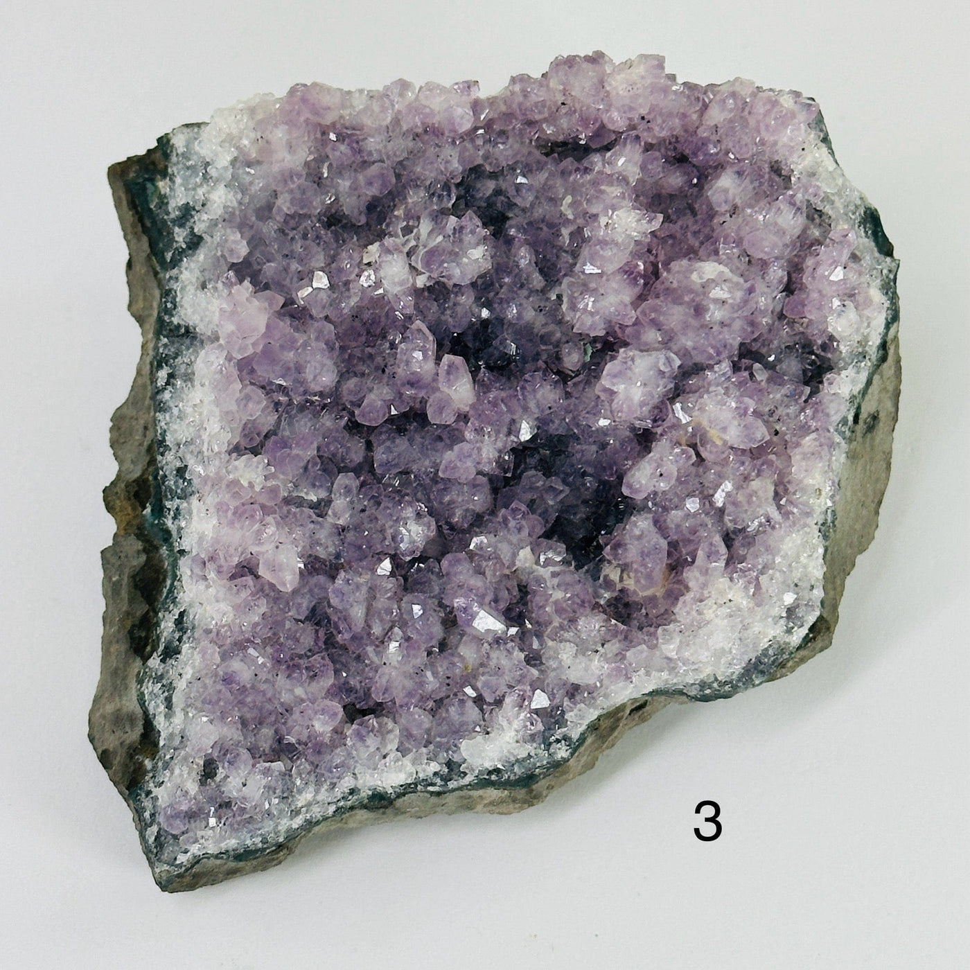 amethyst cluster with decorations in the background