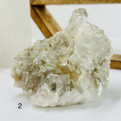 crystal quartz cluster with decorations in the background