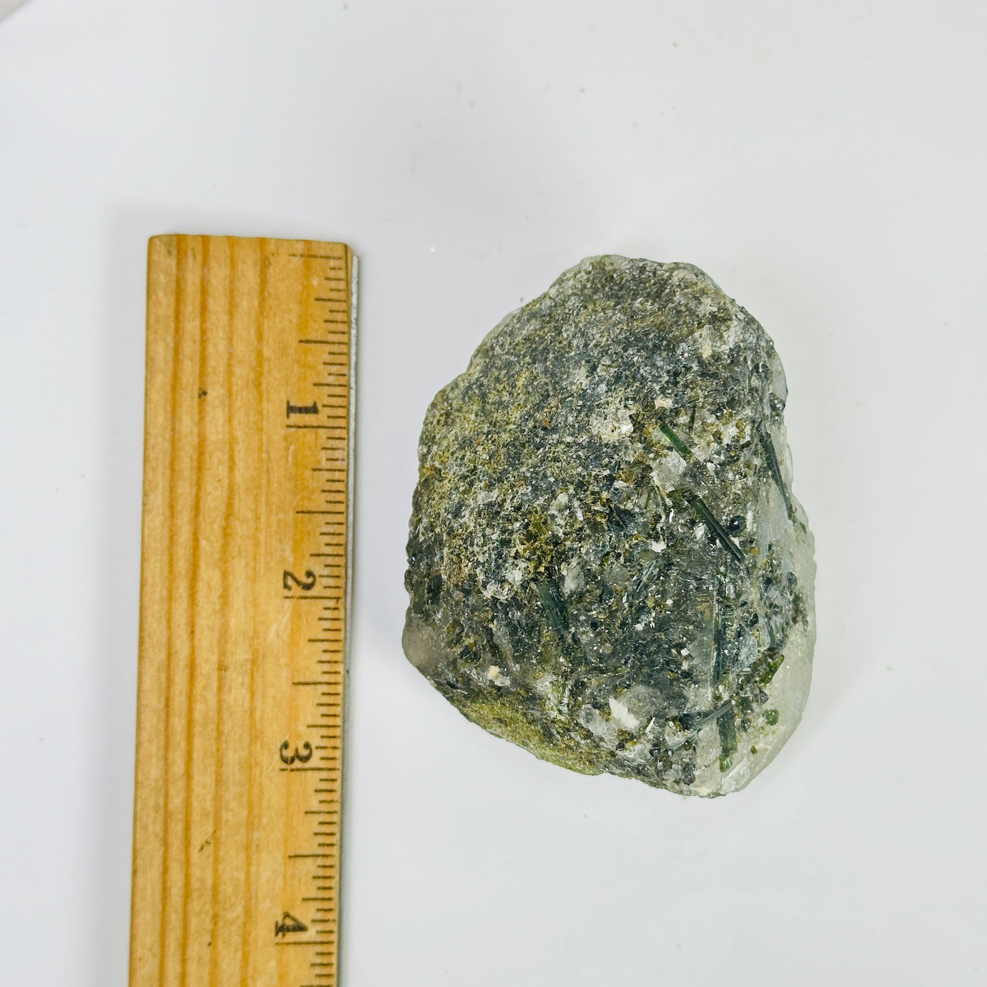 tourmaline next to a ruler for size reference