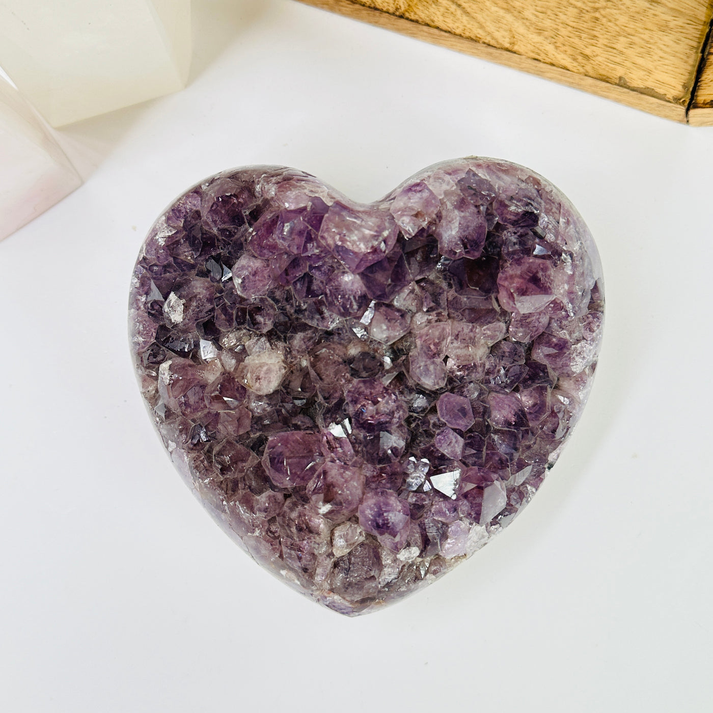 amethyst heart with decorations in the background