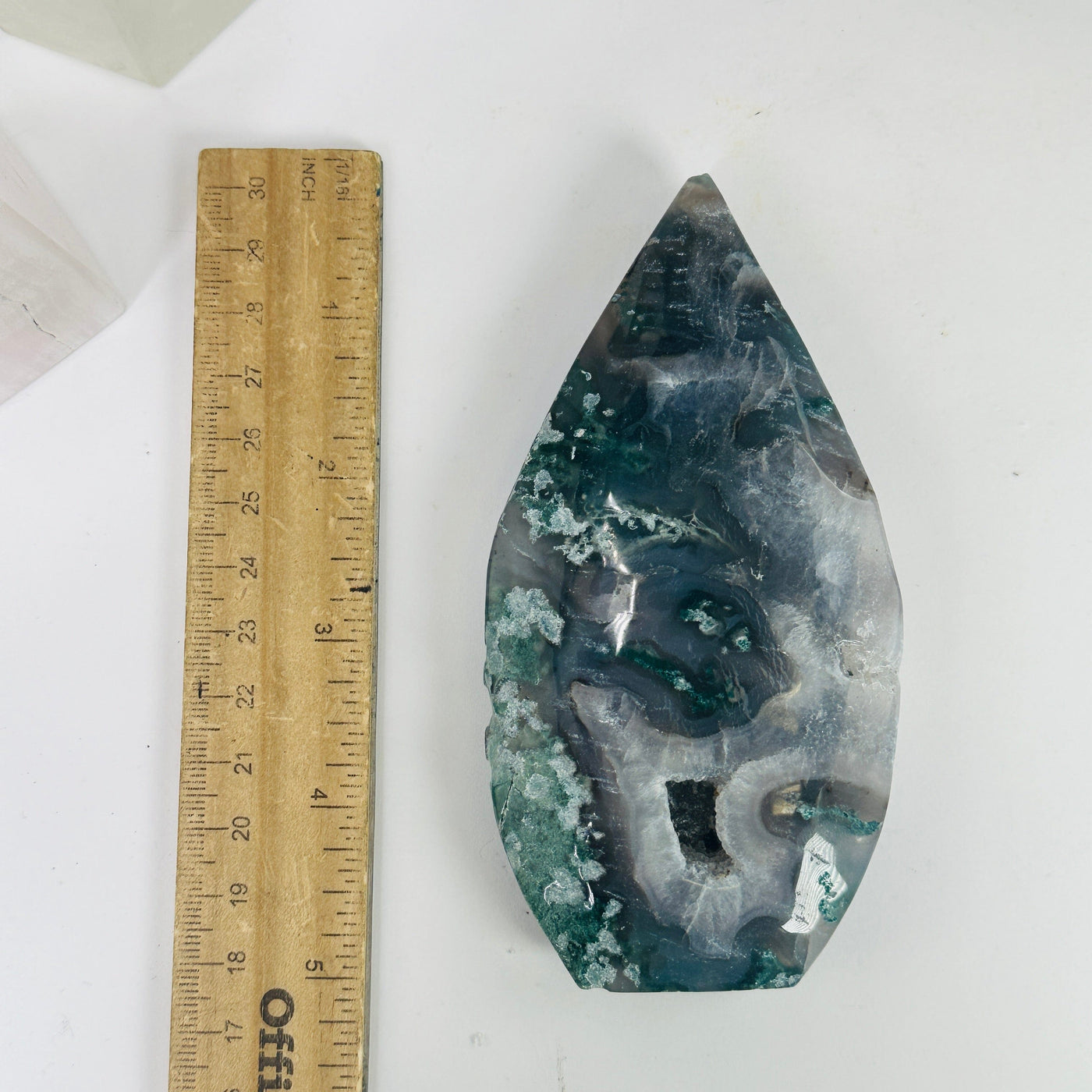 agate cut base next to a ruler for size reference
