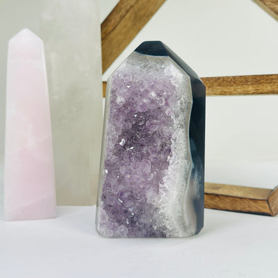 amethyst point with decorations in the background