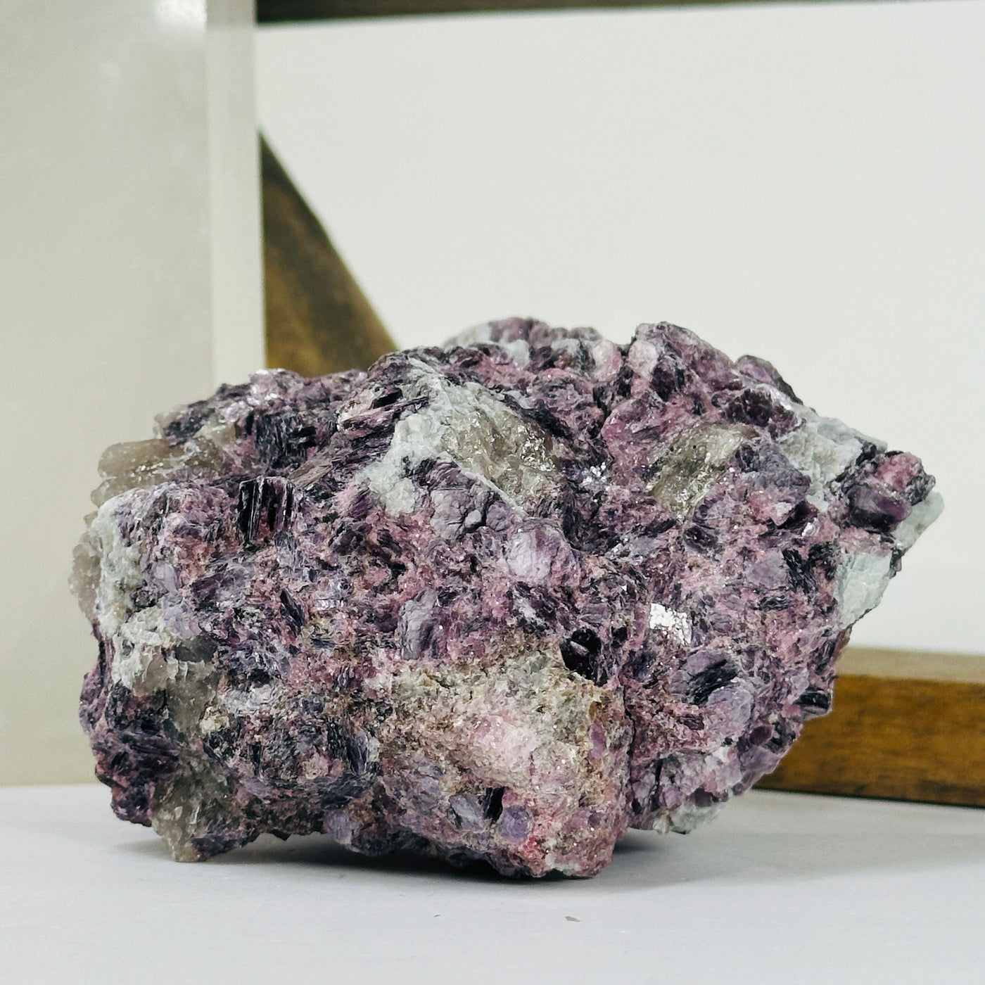 lepidolite cluster with decorations in the background