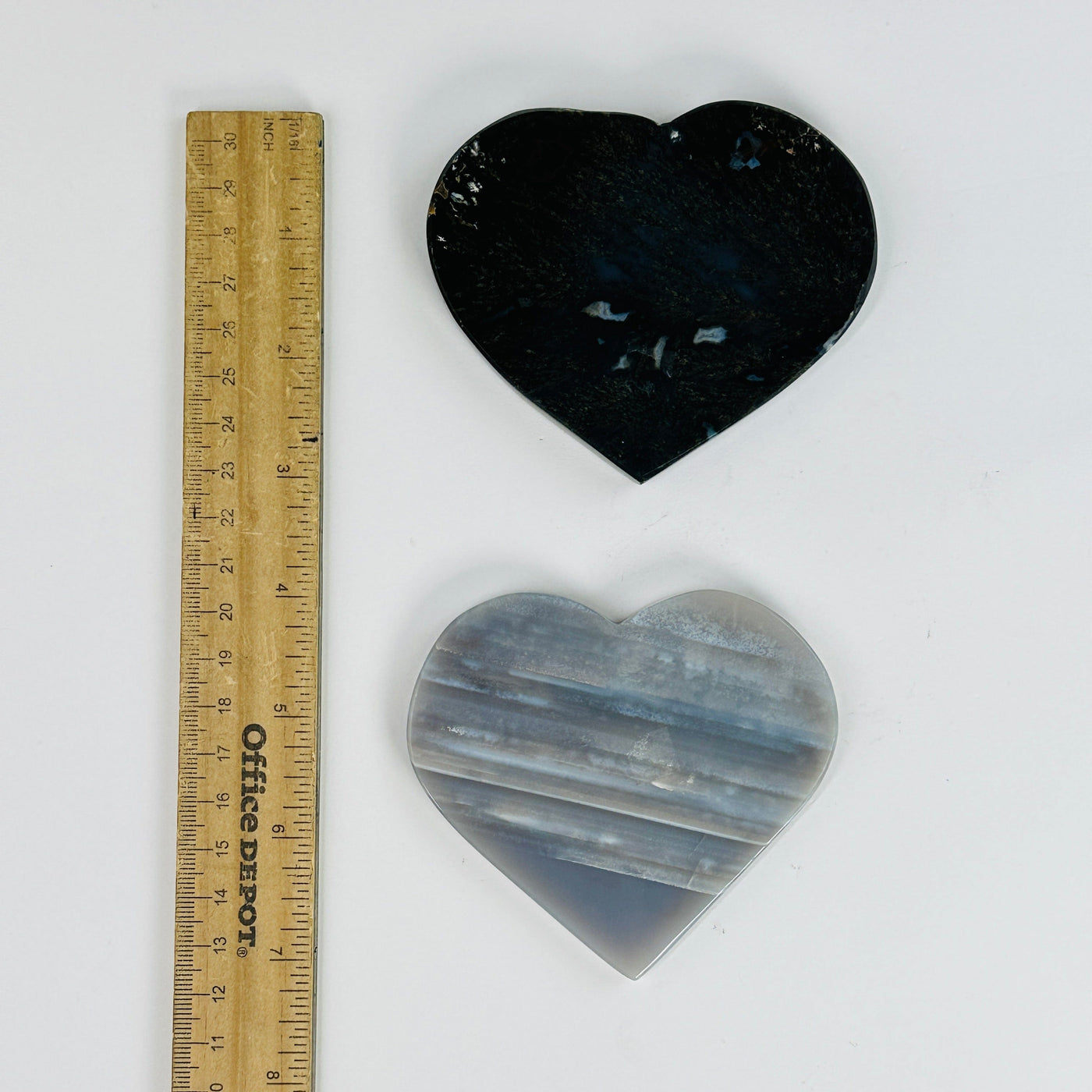 agate hearts next to a ruler for size reference