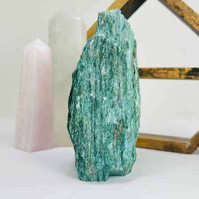 fuchsite cut base with decorations in the background