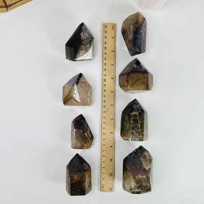 ametrine polished points next to a ruler for size reference