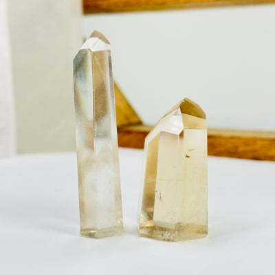 crystal quartz point with decorations in the background