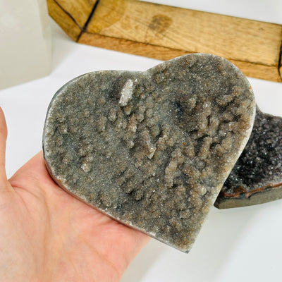 amethyst heart with decorations in the background