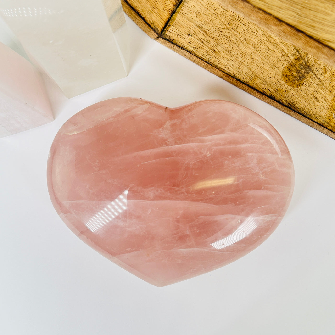 rose quartz heart with decorations in  the background